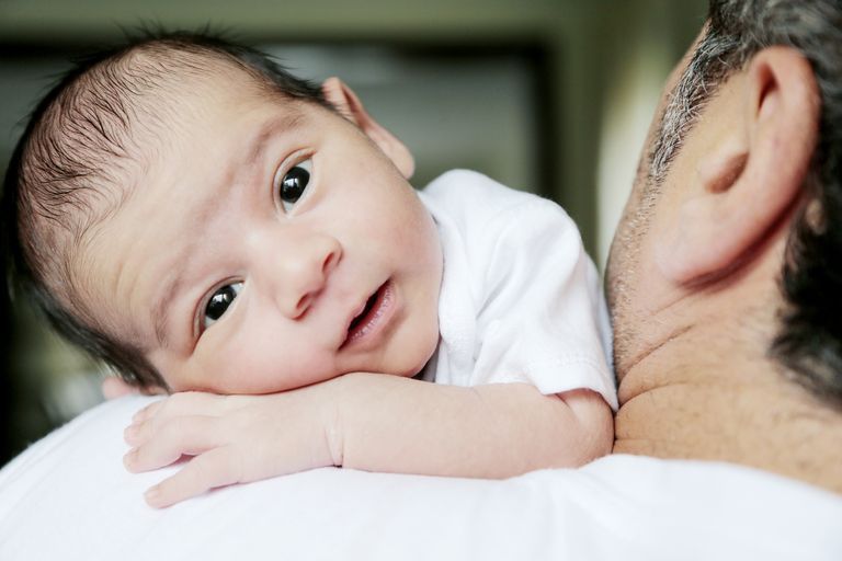 Baby Lies On Father's Shoulders